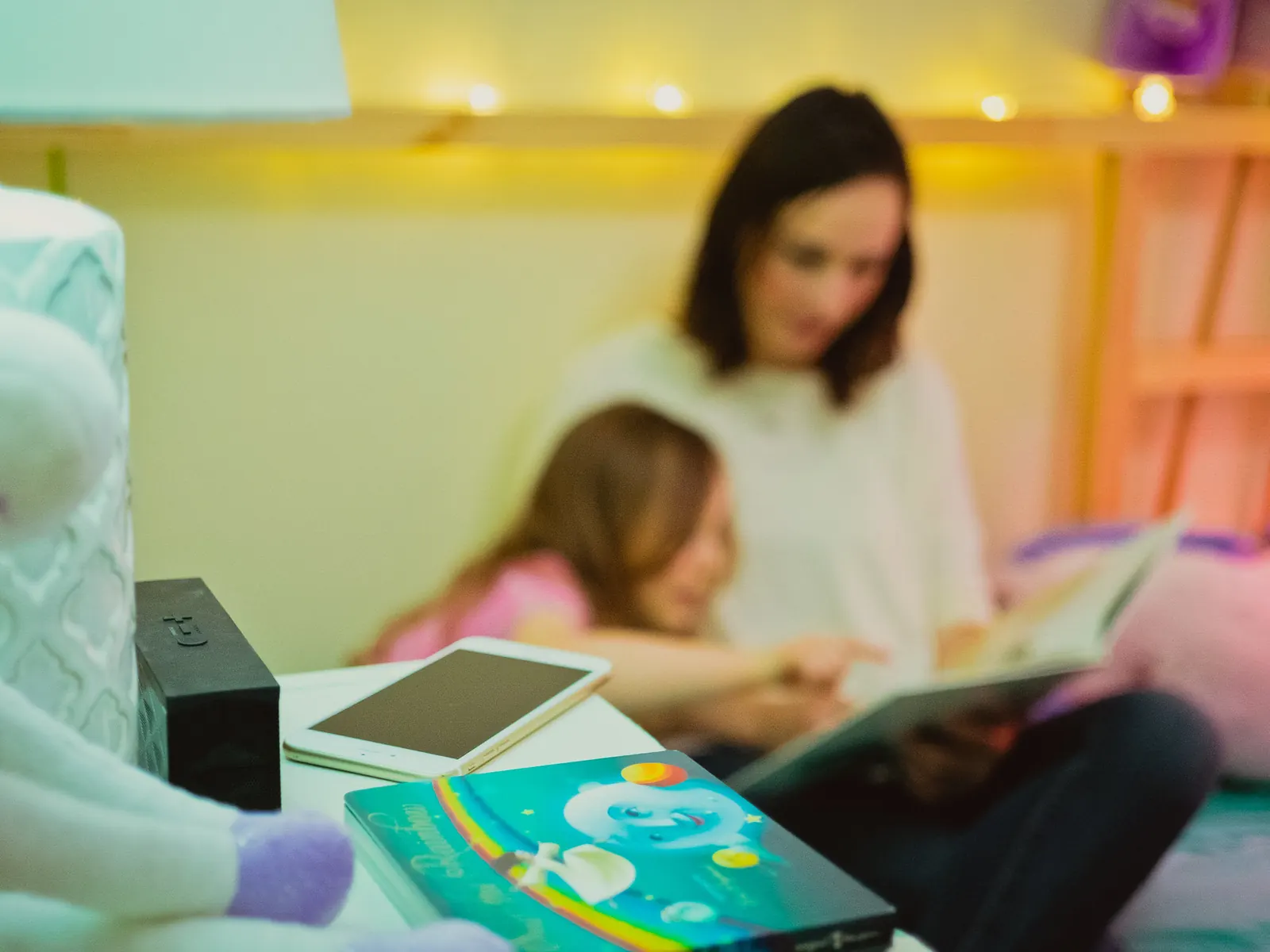 The Campfire hub and tablet on a nightstand beside the book