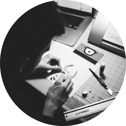 Kyle cutting a paper character at a craft desk